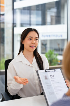 Job applicants having an interview with Human resource manager jobs interviewing with confident candidate at business firm office give cv resume. Job Interview with headhunter agent and applicant.
