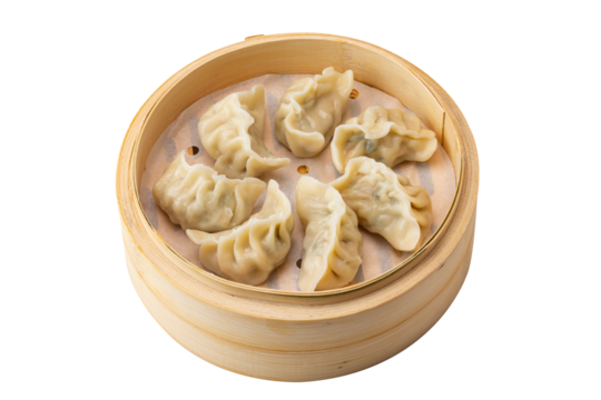 Steamed Chineses dumplings in a bamboo steamer on white background.