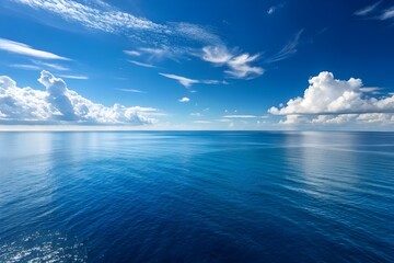 Peaceful Blue Ocean Horizon Under Clear Sky with Clouds