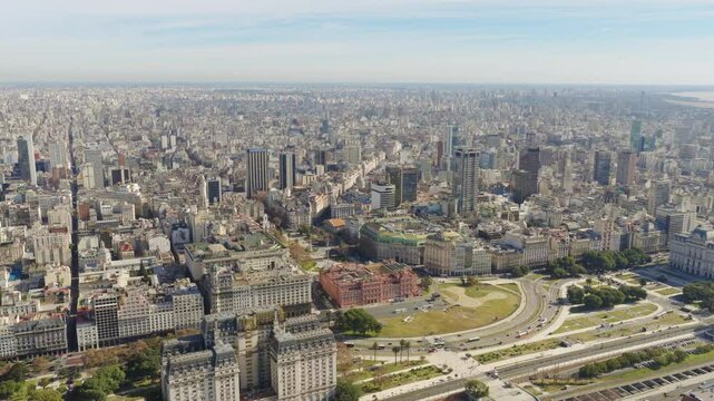 Drone footage capturing the iconic Casa Rosada and the surrounding urban cityscape of downtown Buenos Aires, Argentina, on a clear day.