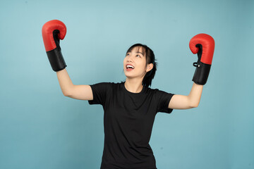 Celebrating victory in a boxing studio with bright blue background and enthusiastic expressions...