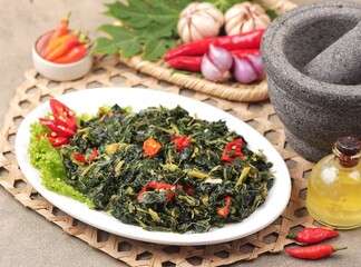 Tumis Daun Pepaya. Sauteed papaya leaves are papaya leaves sautéed with garlic, shallots and red...