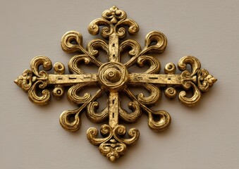Golden cross emblem with intricate details on a textured surface, ornate design