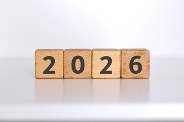 2026 written on wooden blocks. Turn of the new year. New year's resolution.