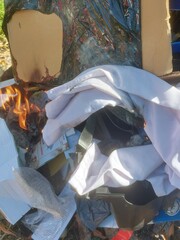 Sungai Petani, Kedah, Malaysia – July 5, 2025 – A pile of mixed trash burning in an open field...