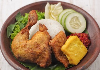 Pecel ayam or penyet ayam or fried chicken in Indonesia is the name of a typical Javanese food consisting of fried chicken and tomato sauce.