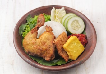 Pecel ayam or penyet ayam or fried chicken in Indonesia is the name of a typical Javanese food consisting of fried chicken and tomato sauce.