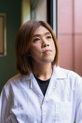 Transgender non binary doctor face closeup in office