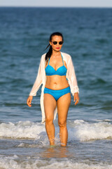Obraz premium Woman in blue bikini relax on beach