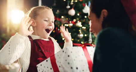 Girl, mom and surprise with gift, Christmas tree and thanks with love, bonding or festive holiday....