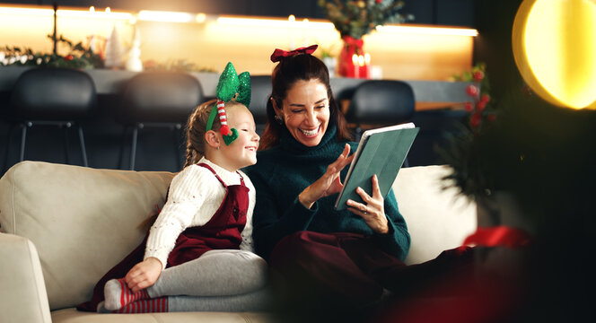 Christmas, happy mother and kid with tablet in home for holiday movie, game and watch cartoon. Xmas, parent and child with tech in living room for festive show, learning and family bonding together