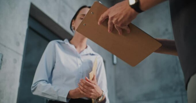 Mailman Bringing Padded Envelope for Recipient to the Office, Getting Client's Signature. Postal Worker Giving Small Parcel with Online Shopping Order to Businesswoman. Delivery Service. Close Up.