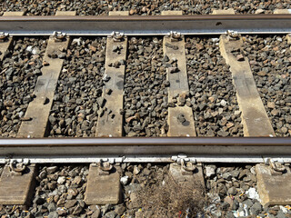 Close-up of railway tracks with gravel ballast and metal rails