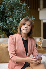 Confident transgender non binary person in smart business attire at stylish indoor cafe restaurant