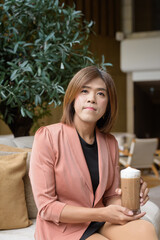 Confident transgender non binary person in smart business attire at stylish indoor cafe restaurant