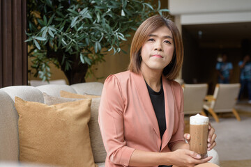 Confident transgender non binary person in smart business attire at stylish indoor cafe restaurant