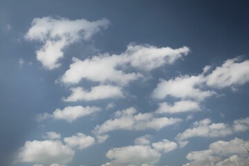 Flat design scene is showing white cumulus clouds drifting across clear blue sky with antenna tip