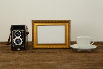 Photo frame, camera and coffee cup on table © vectorfusionart
