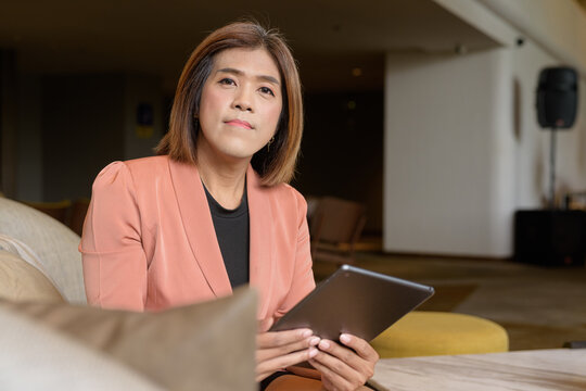 Confident transgender non binary person in smart business attire at stylish indoor cafe restaurant