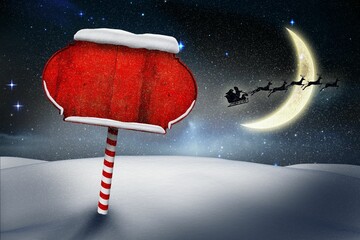 Night is showing red sign atop candy-cane pole in snow beneath stars with Santa sleigh silhouette