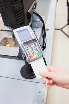 Cropped image of person with credit card reader