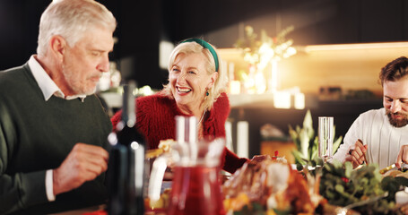 Christmas, dinner and family with laugh in home for bonding, festive celebration or social gathering. Happy people, food or conversation together in house with love, holiday reunion and relationship