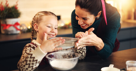 Baking, help and mother in kitchen, girl and bonding together with ingredients, love or flour. Child development, home or mama with daughter, parent or family with growth, culinary skills or learning