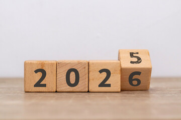 Turn of the new year. Wooden blocks with 2025 change to 2026 with the number five already faded.