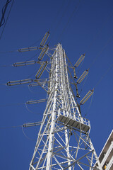 High-voltage transmission tower in Japan under clear blue sky.