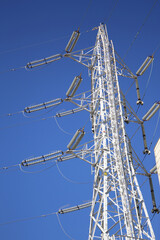High-voltage transmission tower in Japan under clear blue sky.