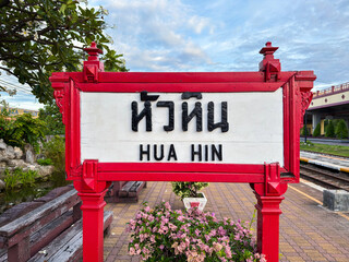 Close-up view of Hua Hin railway station sign with Thai and English text