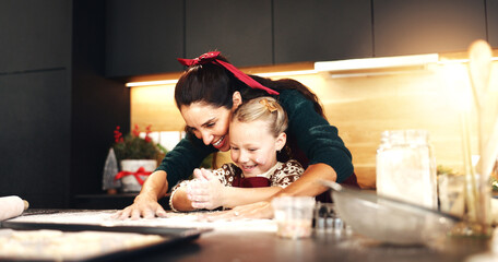Christmas, mother and child baking for learning, love and clapping in home kitchen. Happy parent,...