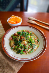 lotek is a traditional salad from Indonesia made from vegetable, chayote, kale, young jackfruit, tempeh, tofu, long beans, and bean sprouts with peanut sauce and cracker