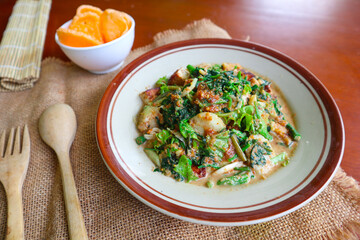 lotek is a traditional salad from Indonesia made from vegetable, chayote, kale, young jackfruit, tempeh, tofu, long beans, and bean sprouts with peanut sauce and cracker