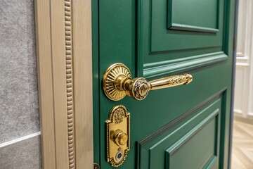 A green door with a gold handle and a keyhole