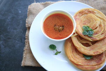 Roti Canai or Paratha Bread with Curry Sauce, Chilli Flakes and Yogurt, Top View