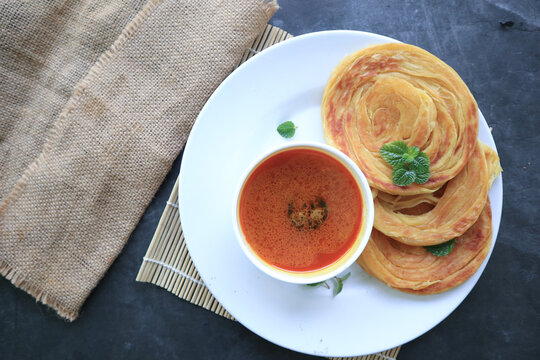 Roti Canai or Paratha Bread with Curry Sauce, Chilli Flakes and Yogurt, Top View