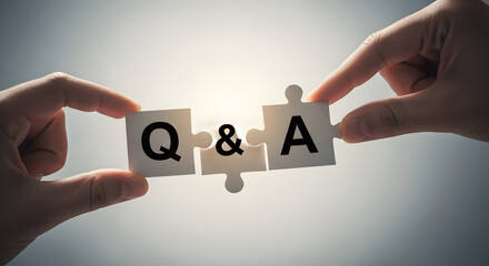 Two hands assemble puzzle pieces displaying the letters Q&A, representing a question and answer session.