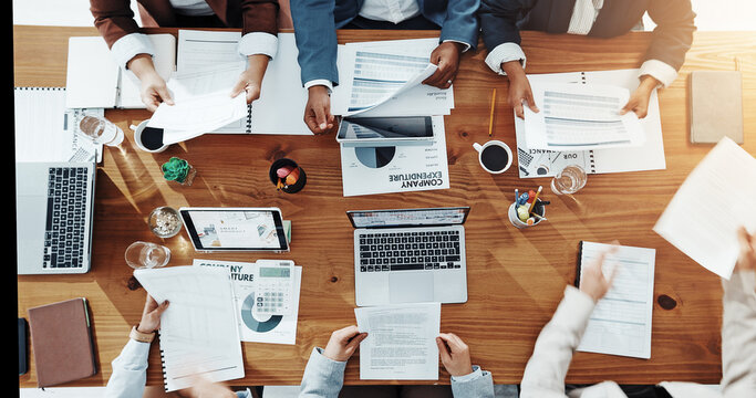 Business, hands and people with paperwork in meeting for company expenditure, budget and auditing. Above, accounting teamwork and screen for revenue stats, financial analysis or forecasting in office