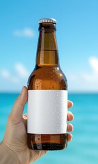 A hand holds a cold, wet beer bottle with a blank white label against a beautiful tropical ocean and sky background. An ideal product mockup for summer beverage branding and advertising.