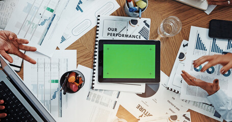 Hands, tablet and green screen at meeting with finance, app and above with graphs at office. Men, women and paperwork with space, charts and feedback for performance, revenue or chromakey at company