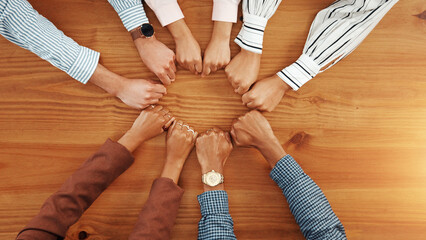 Business people, above and fist on table with unity, collaboration and team building. Support,...