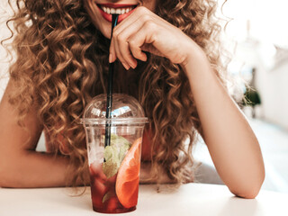 Young beautiful smiling hipster woman with afro curls hairstyle. Woman in summer trendy clothes...