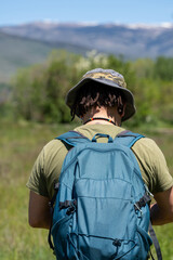 Unrecognizable hiker enjoying his vacation in an alpine meadow