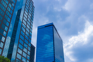 A cityscape of moving cloud reflecting the office building at the business town