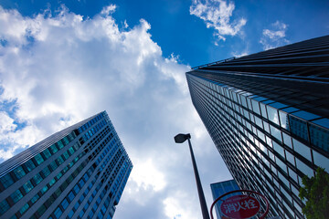 A cityscape of moving cloud reflecting the office building at the business town