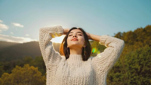 Reverie in Sunshine: A woman with her eyes closed, her arms gently raised, embraces the warmth of sunlight, revealing an atmosphere of serene relaxation and contentment.