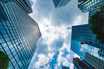 A cityscape of moving cloud reflecting the office building at the business town