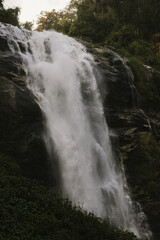 Scenic view of Siriphum Waterfall in Chiang Mai, Thailand &ndash; a tall waterfall flowing through green jungle in Doi Inthanon National Park.