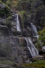 Siriphum Waterfall in Doi Inthanon, Chiang Mai, Thailand – tall mountain waterfall flowing through dense tropical forest in a serene natural setting.